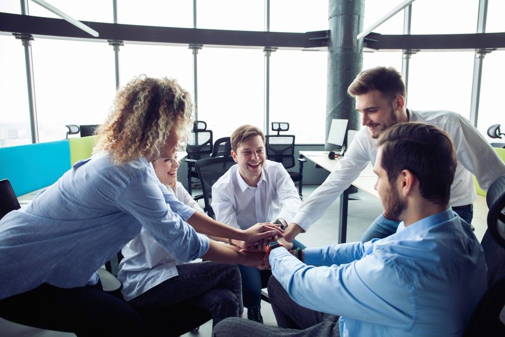 Group of diverse employees in a modern office environment.